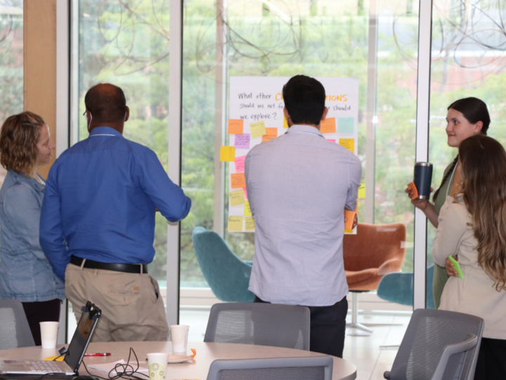 Research Jam participants discuss and ideate ideas with stickynotes